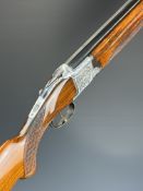 Laurona 12 bore over and under shotgun with engraved scenes of dogs and birds to the locks,