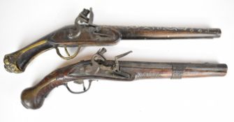 Two flintlock pistols one with indistinctly named lock, chequered grip, brass butt cap, wrist