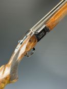 Miroku 12 bore over and under ejector shotgun with engraved action, named underside, chequered