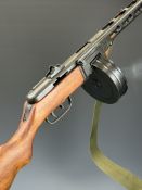 Replica PPsh sub machine gun with rotary drum magazine, canvas sling and wooden stock, 84cm long.