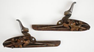 A pair of William Powell percussion hammer action shotgun locks with scrolling engraving to the