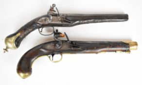 Two flintlock pistols one with indistinctly named lock, engraved brass trigger guard and barrel
