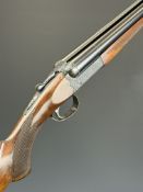 SKB 12 bore side by side ejector shotgun with ornately engraved locks, underside, trigger guard, top