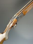 Ibargun 12 bore over and under shotgun with engraved locks and thumb lever, chequered semi-pistol