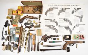 A collection of gun parts and accessories including antique pistol stocks and barrels, cartridge