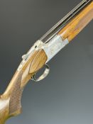 Browning B2G 12 bore over and under ejector shotgun with engraved scenes of birds to the locks,