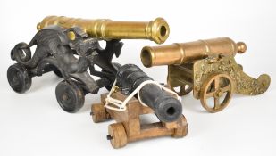 Three model, desk or signalling cannon, the largest with cast iron base in the form of dragons and