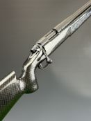 Remington Model .308 Winchester bolt-action rifle with custom carbon fiber effect stock, textured