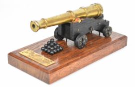 1:16 scale model of a 12pdr ship's cannon with 7.5 inch brass barrel, mounted on wooden base with