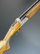 Italian 12 bore over and under ejector shotgun with engraved scenes of birds to the locks and