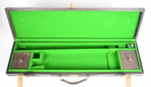 Leather and brass bound shotgun carry case with fitted interior, 83 x 23 x 8cm.