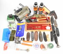 A collection of gun and shooting accessories including Flextone Vengeance FLX100 game call with user