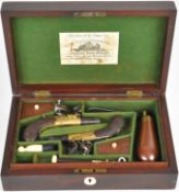 A pair of flintlock pocket pistols attributed to Joseph Egg & Sons each with engraved brass round