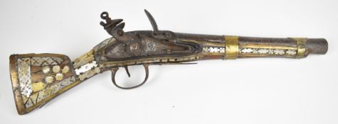 Eastern flintlock pistol with mother of pearl and brass decoration to the stock, lion engraved