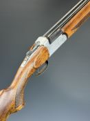Rota 12 bore over and under ejector shotgun with engraved scenes of dogs and birds to the action and