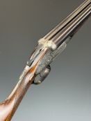 E Wilson 12 bore sidelock side by side ejector shotgun with scroll engraving to the named locks,