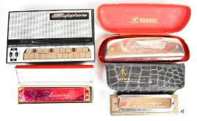 Three harmonicas by Hohner and similar, together with a Dubreq Stylophone.