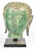 Life sized patinated bronze bust / mask of Buddha, on wooden base, H36cm