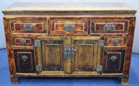 A 19thC Chinese jointed elm sideboard with five drawers, central two door cupboard and two cubby