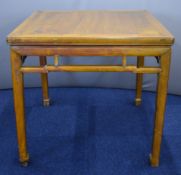 19thC Chinese jointed elm table with moulded supports, raised on four circular legs, W92 x D92 x