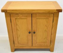 Modern oak two door cupboard with two shelves behind the double doors, W75 x D35 x H75cm