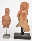 Two pre-Colombian pottery figures on wooden/metal stands, tallest 30cm