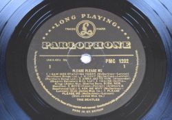 The Beatles Please Please Me (PMC 1202) with black and gold Parlophone label. This appears to be the