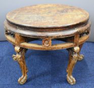 19thC or earlier circular jointed low table with carved flower decoration, raised on four carved