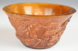 A carved horn libation cup decorated with mountains, figure and pagoda, H5.5cm