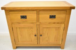 Modern oak sideboard with two drawers above cupboard doors with two shelves within, W105 x D45 x