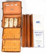 Leather cased bamboo and bone Mah Jong set with mahogany four winds holders, the instructions