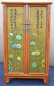 19th/20thC Chinese two door canted wedding cabinet with fitted interior, the doors with peony,