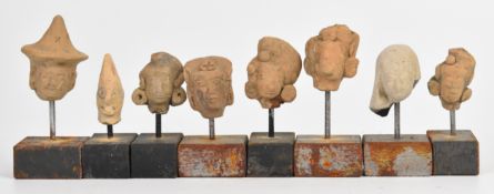 A collection of pre Colombian pottery masks, figures and artefacts, probably 14th/15thC, tallest