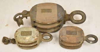 Three vintage block and tackle / pulleys or winches, largest 65cm