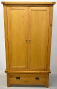 Modern oak wardrobe or cupboard, the top section having hanging rail and single movable shelf, the
