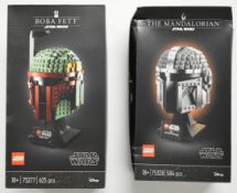 Two Lego Star Wars The Helmet Collection sets comprising The Mandalorian 75328 and Boba Fett