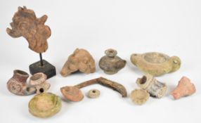 Antiquities including Roman redware, pottery Buddha busts etc., tallest 12cm