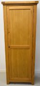 Modern oak cupboard or wardrobe, the single door opening to reveal a hanging rail and four removable