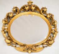 Circular bevelled glass hanging mirror with ornate giltwood frame, diameter 109cm