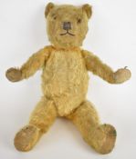 Vintage Teddy bear with golden mohair, disc joints and stitched features, height 45cm.