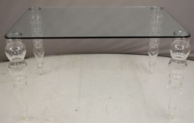 Designer glass table raised on graduated bulbous glass legs, W130 x D90 x H72cm