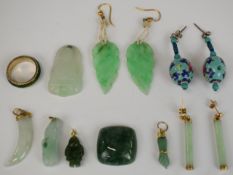 Four jadeite pendants, two pairs of jadeite earrings, one pair in the form of leaves and the other