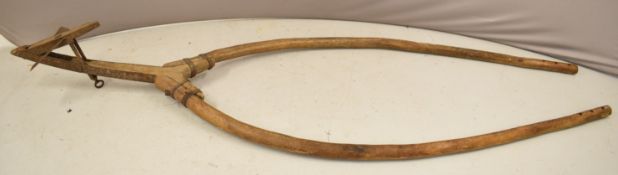 A 19thC horse or ox drawn metal bound wooden plough with metal ploughshare, length 290cm