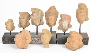 A collection of pre Colombian pottery masks, figures and artefacts, probably 14th/15thC, tallest