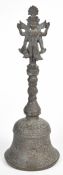 Large bronze Indian temple bell with foliate decoration and Hindu deity finial, H38cm