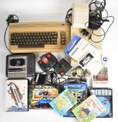 Commodore 64 retro home computer together with disk drive, power supply, cassette deck, manual,