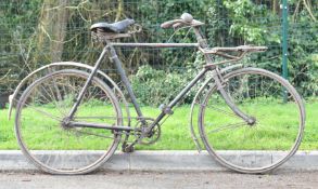 Vintage tradesman's bicycle, likely pre war, with rod brakes, bell, bolt on steel front rack and
