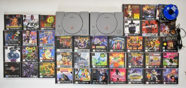Two Sony PlayStation One (PS1) consoles together with two controllers, forty two boxed games and a