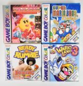 Four Nintendo Game Boy Color retro computer games comprising Wario Land 3, Super Mario Bros