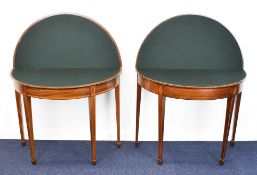 Near pair of Regency inlaid and crossbanded satinwood fold over games tables raised on tapering legs